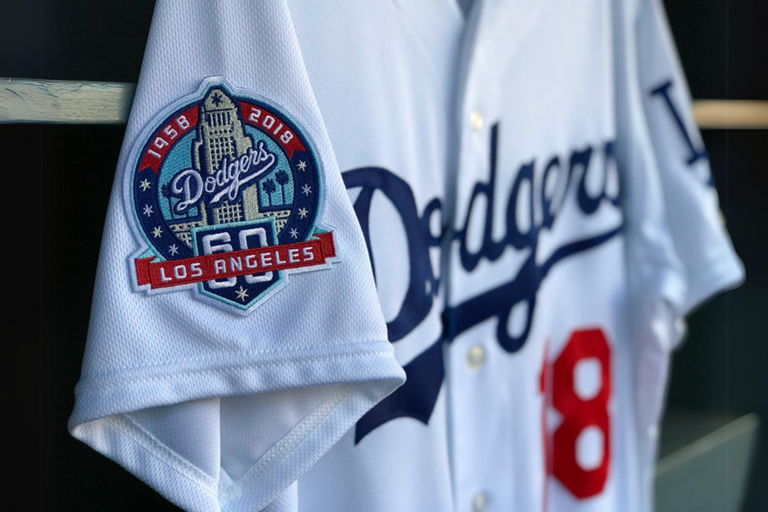 Close-up of a Los Angeles Dodgers baseball jersey with a commemorative patch on the sleeve.