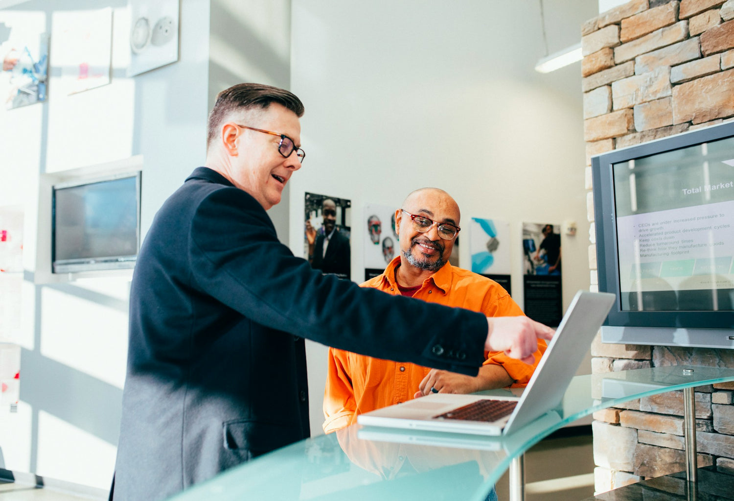 Client onboarding meeting with a professional holding a form, while another person, partially blurred, listens attentively.