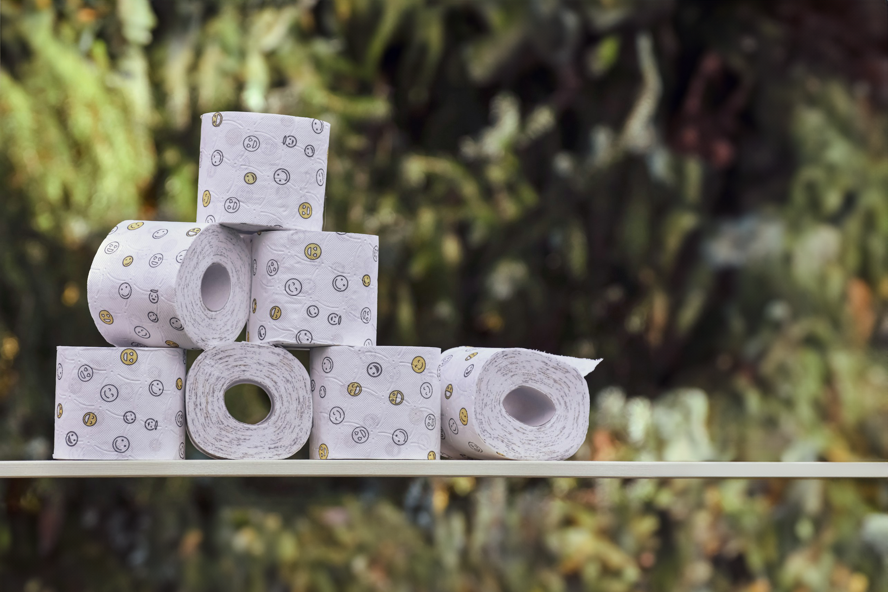 Stack of printed toilet paper rolls from Trustline Enterprises, featuring a stylish design ideal for enhancing the bathroom experience in hospitality and corporate settings.