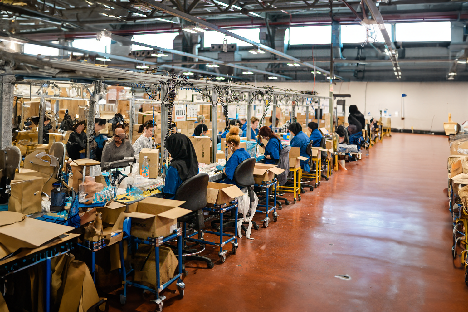 Workers assembling products on a production line in a factory.