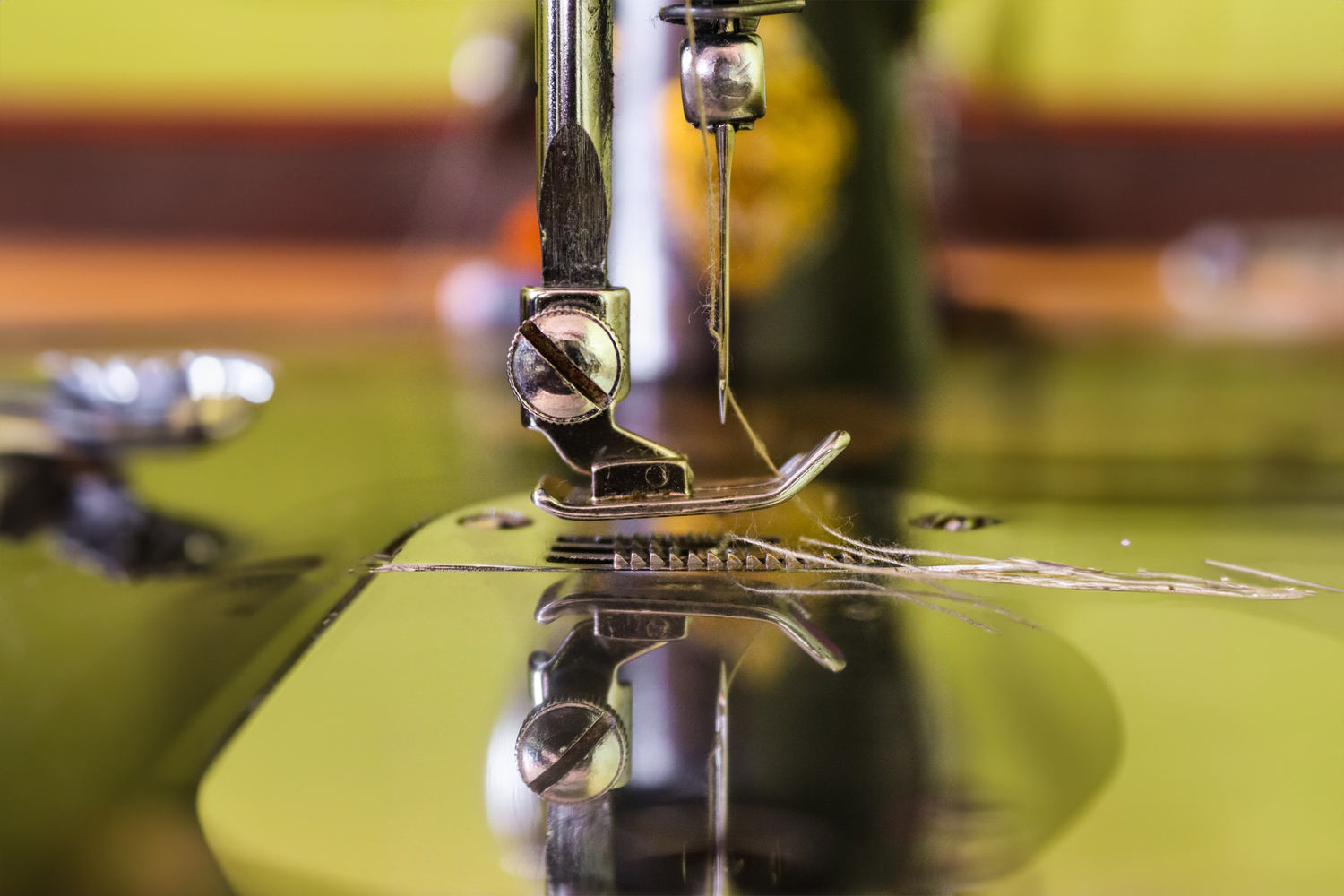 Close-up of a sewing machine needle in operation.