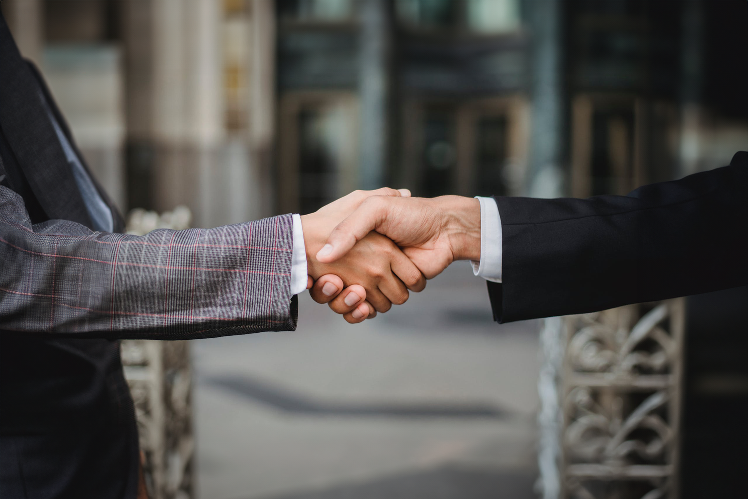 Close-up of a handshake between two business professionals, symbolizing agreement or partnership.